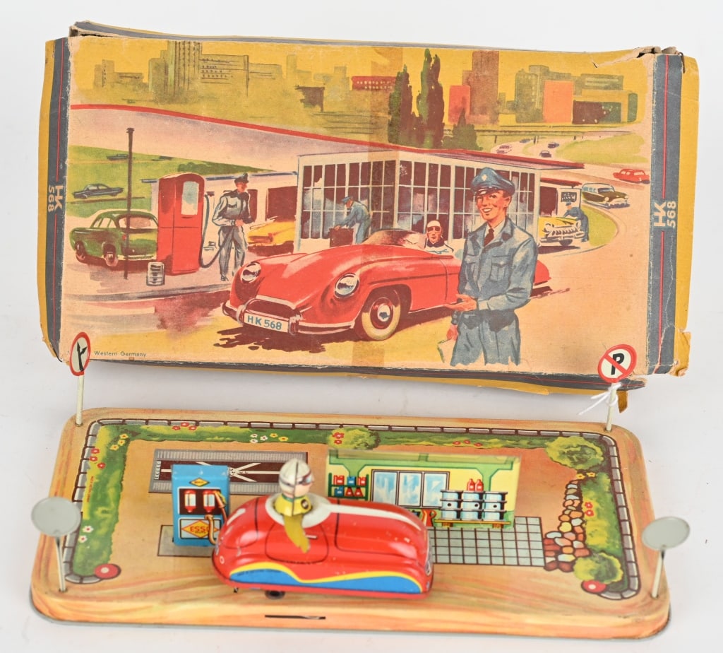 GERMAN HUKI TIN WINDUP FILLING STATION CAR w/ BOX: The toy has great graphics and colors. Windup auto works. Includes colorful original box with wear. made in western Germany. 9" by 5" Excellent