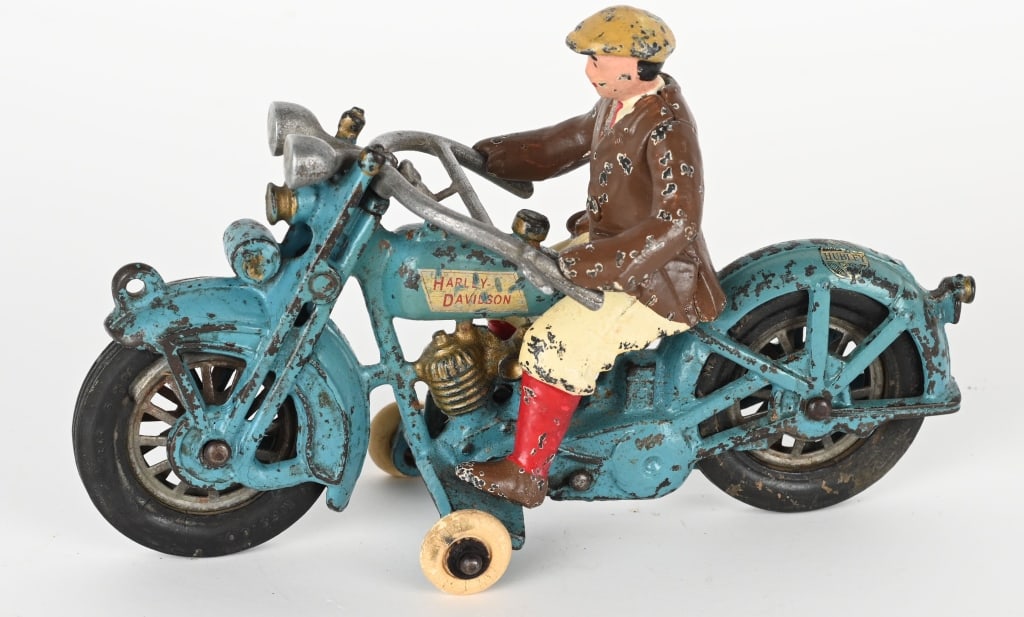 HUBLEY CAST IRON HARLEY DAVIDSON SOLO MOTORCYCLE: Hubley cast iron blue solo motorcycle with civilian rider. The cycle has some touch up as seen under black light. The tank decal and Hubley decal on rear fender are original. The original tires and si