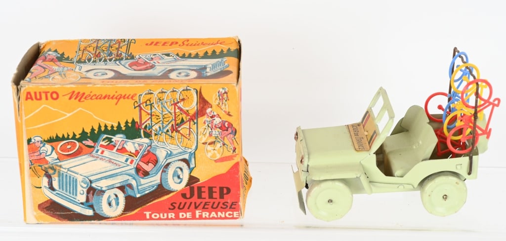 FRENCH TIN TOUR DE FRANCE JEEP w/ BOX: Tin Tour De France Jeep carrying 4 plastic bicycles. Includes colorful original box. 5 1/2" Excellent