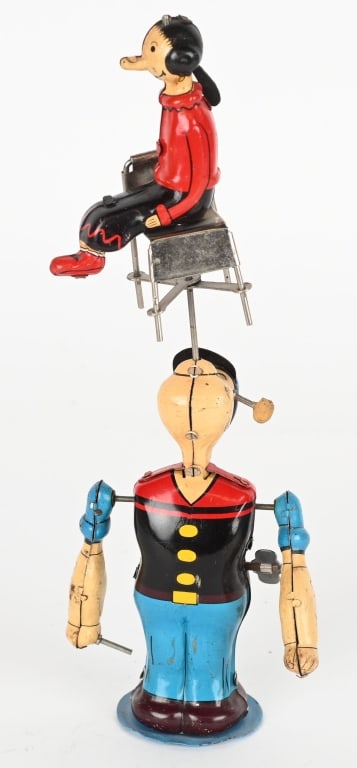 LINEMAR TIN WINDUP POPEYE SPINNING OLIVE OYL: All original and complete. Has very nice colors. Windup works. A very nice example of this desirable toy. 9 1/2" Excellent