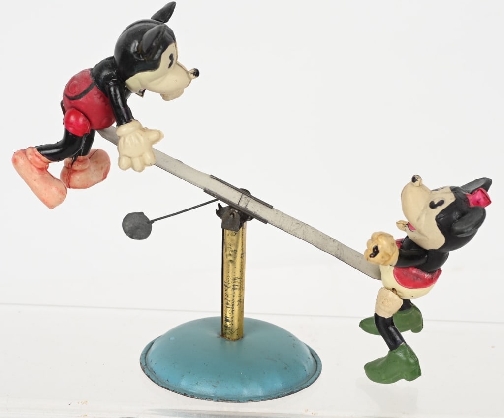 JAPAN CELULOID MICKEY & MINNIE SEE SAW: Scarce celluloid and tin Mickey and Minnie Mouse See Saw. All original and winds form the bottom. Toy has nice colors. 7" Excellent