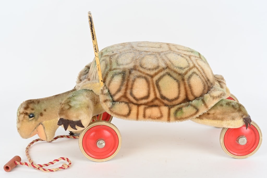 STEIFF MOHAIR RIDE ON TURTLE CIRCA 1940'S: Steiff Mohair Ride-on Turtle, CIRCA 1940's Beige, light yellow and light green upper body with brown markings. Some fading Has yellow underside, with a peach felt open mouth, round black eyes, and bro