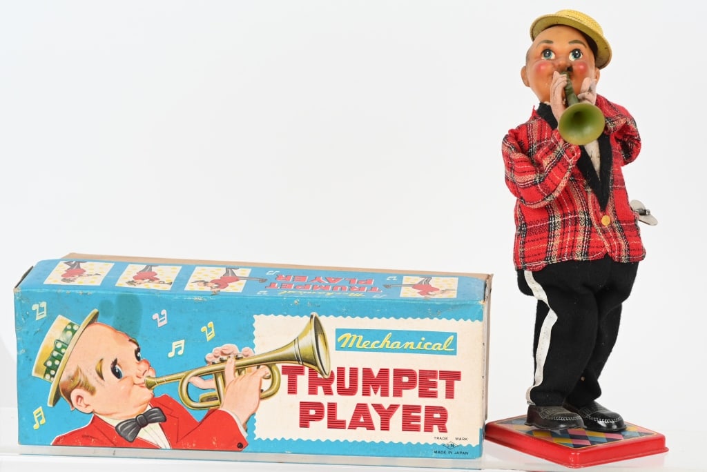 JAPAN WINDUP TRUMPET PLAYER w/ BOX: Japan Trumpet player with the original box. Worked when tested. Has a spot of corrosion on hat and discoloration on face. May clean to a higher grade. 10" Very Good-Excellent