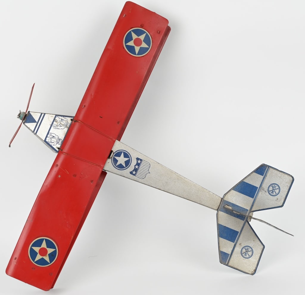 LARGE EARLY MARX TIN ARMY BOMBER BI-PLANE: Impressive large Marx tin Bi-plane with a 25 1/2" wingspan. Nice litho graphics and colors. Slight bend to wing on left side. Overall a wonderful example. Excellent