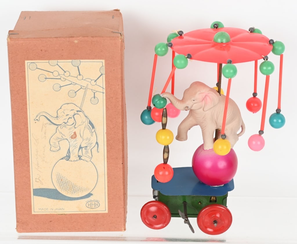 JAPAN CELLULOID WINDUP ELEPHANT ON BALL w/ BOX: The toy is complete and all original. Worked when tested. Includes original box. 7" Excellent
