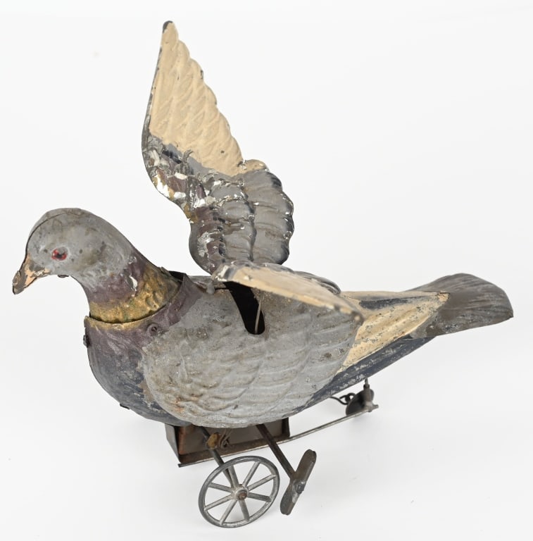 EARLY GERMAN HANDPAINTED TIN WINDUP PIGEON: The toy is all original and the windup worked when tested. It did hang up some. Bellows is not working. 8 1/2" Excellent