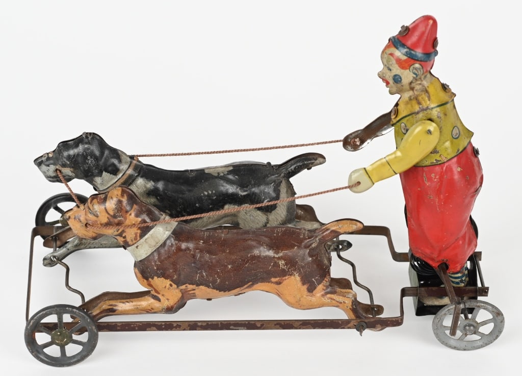 GERMAN TIPPCO TIN WINDUP CLOWN ON DOG CART: The toy is all original and has nice action. Worked when tested. Dogs seem to gallop as toy moves forward, 8" Excellent