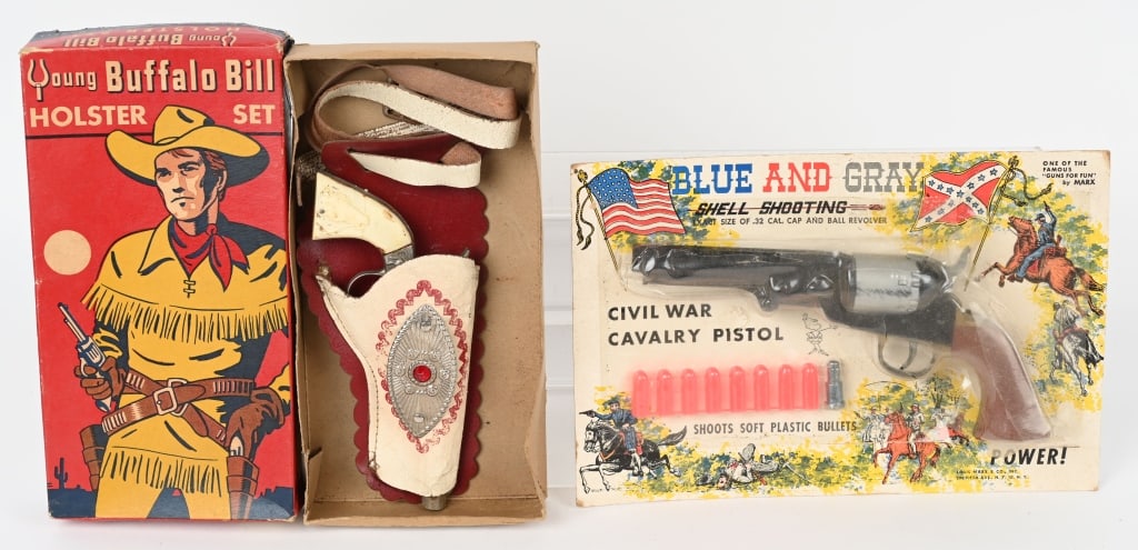 2- CAP PISTOLS, MARX & LESLIE HENRY, w/ BOXES: Lot includes 1. Young Buffalo Bill holster set. Die cast cap gun is working. Needs cleaning 2. Marx Blue & Gray cap pistol. Packaging open with scuff on cylinder. Bullets still on card. Action works.
