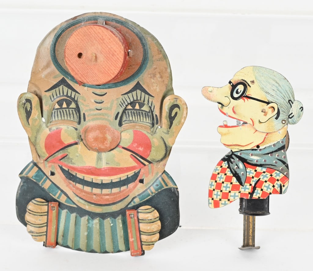 2- EARLY GERMAN TIN SQUEEZE TOYS: Lot includes 1. Clown with accordion, works bellows not working. 2. Old lady sparkler, works but needs a flint. Largest is 6 1/2" Very Good-Excellent