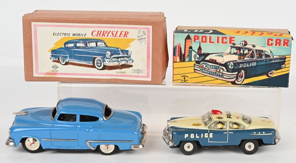 2- JAPAN TIN CARS w/ BOXES: Includes Battery Operated Chrysler that is not working. Plus Tin Friction Police Car. Both great original condition. Boxed. Largest 8" Excellent