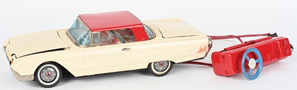 JAPAN TIN BATTERY OP THUNDERBIRD, OPENING HOOD: Japan tin battery op Ford Thunderbird with opening hood and trunk. Worked when tested. Car body has been repainted, and remote wires taped. A scare example in any condition. 11" Very Good-Excellent