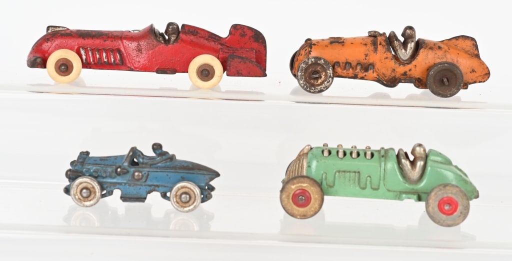 4- CAST IRON RACE CARS: Lot includes: 1. 6" Red Hubley, original paint, replaced tires Very Good, 2. 4 3/4" Green Hubley, original paint, front axle loose. Very Good-Excellent, 3. 5" Orange Hubley , original paint, steel whe