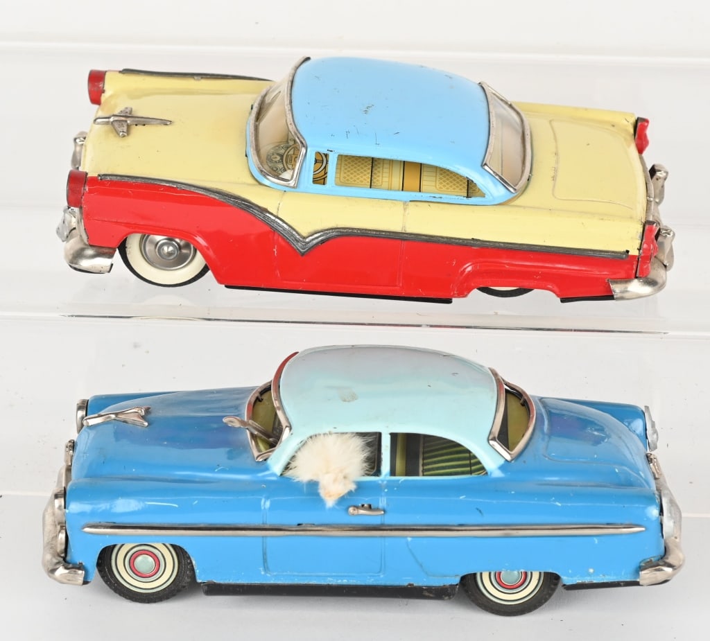 2- JAPAN TIN FRICTION FORDS: Lot includes: 1. 7 3/4" Blue Ford sedan with dog that looks out the window. Friction works. Very Good-Excellent, 2. 7 3/4" 1955 Ford hardtop, friction mechanism is loose, Very Good-Excellent