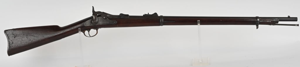 US MODEL 1873 TRAPDOOR SPRINGFIELD CADET RIFLE: SERIAL NUMBER: 114645. BARREL: 29 5/8". CALIBER: 45-70. It features two barrel bands, nose cap, cleaning rod, and standard 1873 rear sight. Lock is marked "US SPRINGFIELD" with eagle in center. Breech