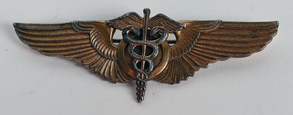 WWII US ARMY AIR CORPS FLIGHT SURGEON PILOT WINGS: US Army Air Corps Flight Surgeon wings measure 3 inches and are maker marked LGB in STERLING 1/20th 10k with a pin assembly that can open roughly 80 degrees. This beautiful set of wings has never been