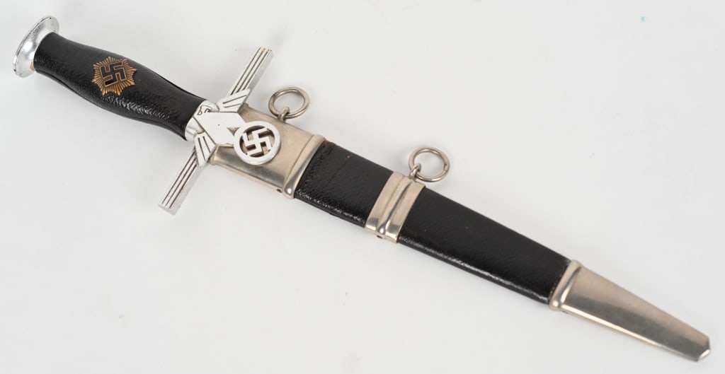 WWII NAZI GERMAN RLB LEADER / OFFICERS DAGGER WW2: Second pattern (1938) RLB leader’s dagger. A 24.5cm nickel/silver plated stiletto style blade with high central ridge. Blade shows wear and sharpening. Leather washer is intact.