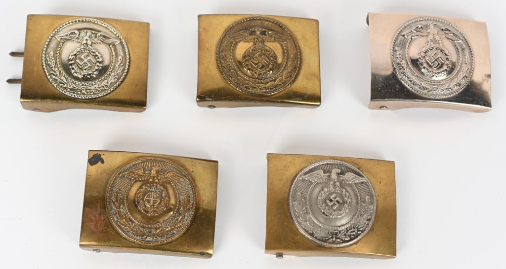 WWII NAZI GERMAN LOT OF FIVE BELT BUCKLES SA NSKK: Lot of five Nazi German belt buckles including 1) NSKK EM/NCO'S BELT BUCKLE. NSKK buckle that measures 50mm x 65mm slightly convex stamped alloy nickel plated one-piece construction buckle features to