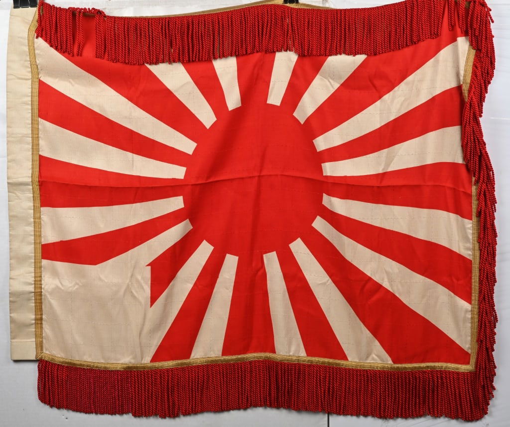 WWII IMPERIAL JAPANESE RISING SUN FLAG W FRINGE: WWII Imperial Japanese Rising Sun Flag measuring 27 X 38 inches excluding the white silk fringe and is double sided with heavy leather reinforced corners with Chrysanthemums. Excellent.31 X 41 inches