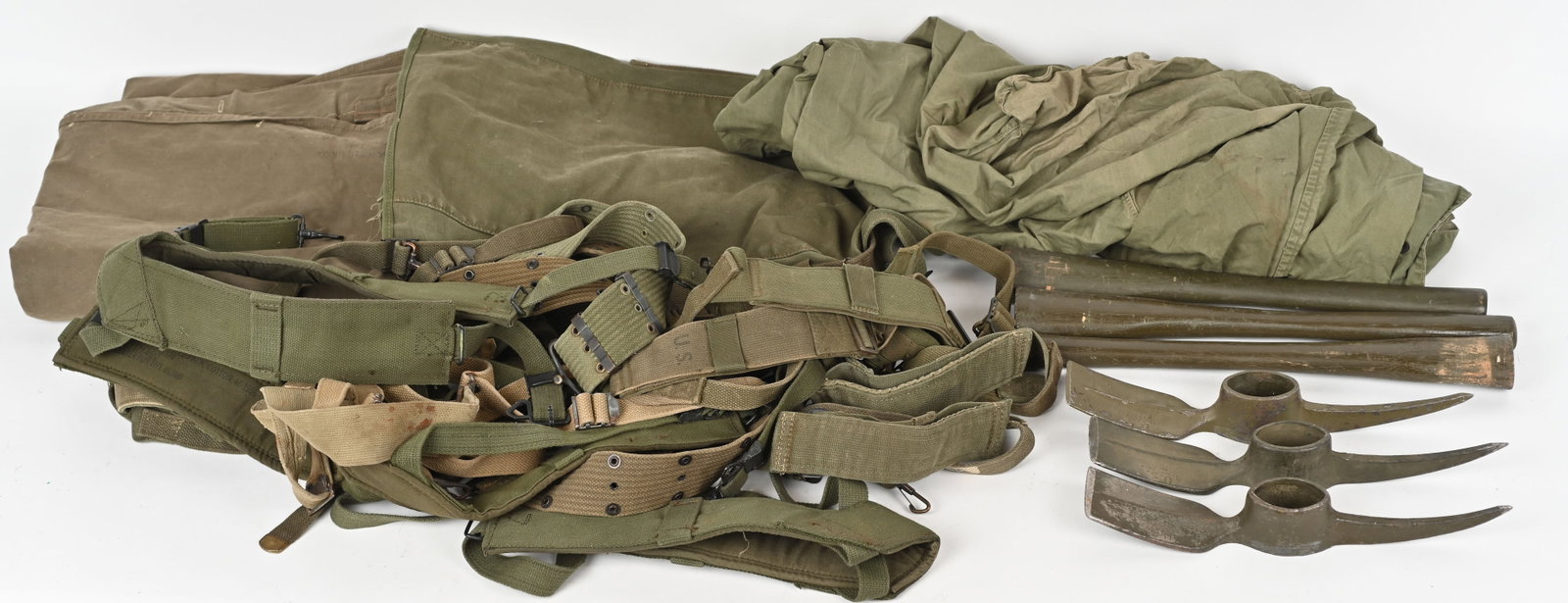 WWII & POST US ARMY FIELD GEAR LOT PICK MATTOCK: Large lot of WWII and Post Field Gear to include 1) U.S. WWII M-1910 Pick Mattock Axe with Wood Handles 2) WWII Sleeping bag Cover 3) 7 Combat Suspenders 4) Pack 5) Shelter Half 6) Three Pistol Belts.