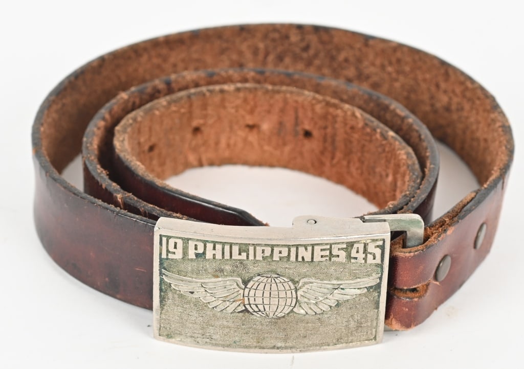 WWII NAVIGATOR THEATER MADE BELT & BUCKLE WW2: Beautiful WWII Theater made in the Philippines belt and buckle. The Nickel buckle is hand chased with 19 PHILIPPINES 45 with a set of US Army Air Corps Navigator Wings to the center. Excellent. Armed 