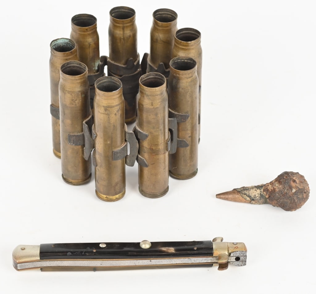 ITALIAN SWITCHBLADE 20MM SHELL CASINGS DUG .50 CAL: Lot to include 1) Italian Switchblade knife measuring 7 inches closed and 13 1/4 inches when extended. Blade has never been sharpened and is marked ITALY INOX. Shows moderate wear. 2) .50 Cal bul
