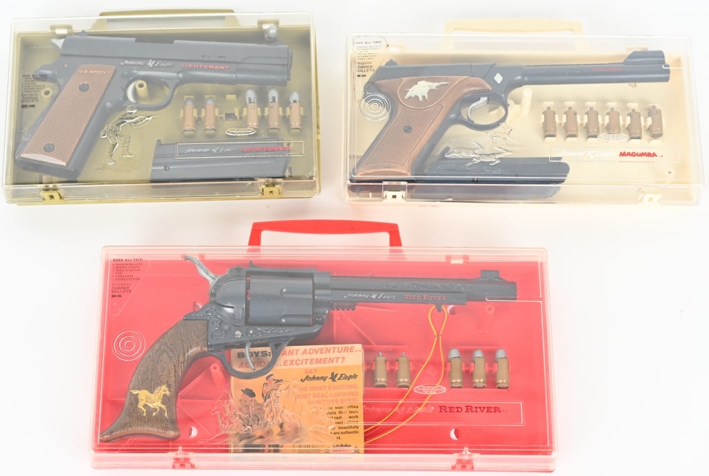 3- JOHNNY EAGLE PISTOLS w/ BOX: Includes Red River, Magumba, and Lieutenant. All Boxed with accessories. The Magumbo has a break to the clear plastic lid. 4" Excellent