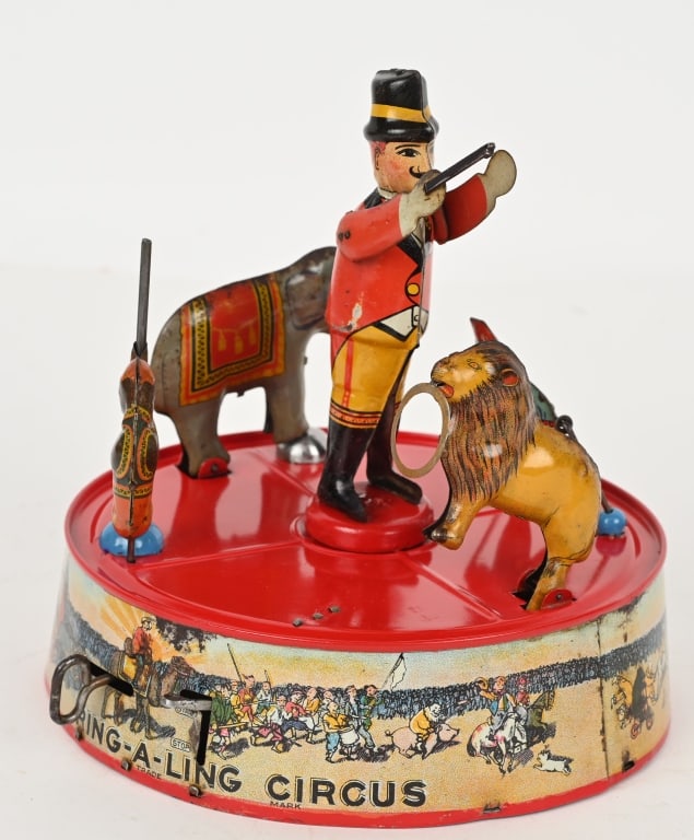 MARX TIN WINDUP RING A LING CIRCUS: Nice graphics and worked when tested. Red on base is repainted and ring master has touch up. Scattered light areas of surface rust. 8" Very Good