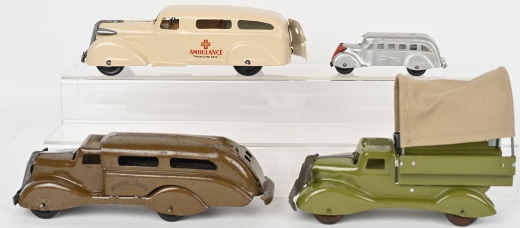 LOT OF PRESSED STEEL TRUCKS: Includes Wyandotte Ambulance restored, Marx Army Transport restored, Marx Medical Corp Truck with broken headlight, and Marx Greyhound Bus. Largest 10 1/2" AS-IS