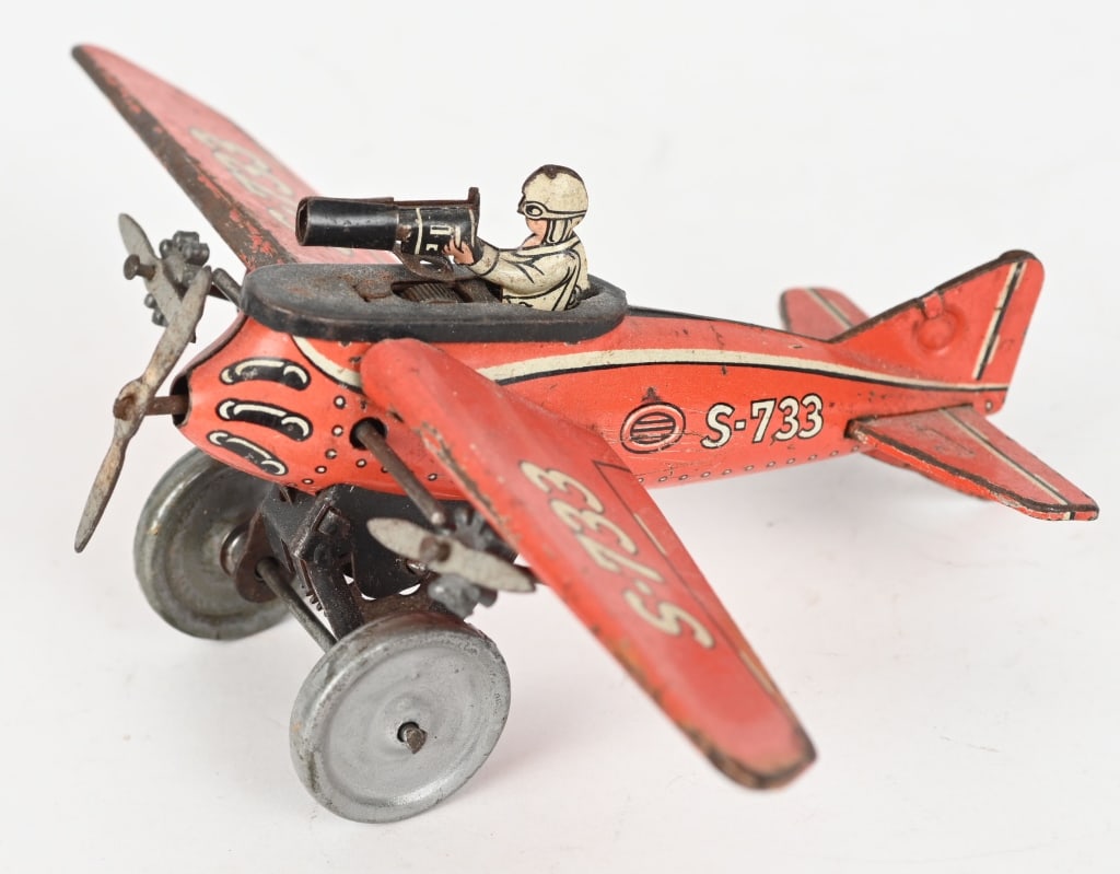 GERMAN GESCHA TIN WINDUP TRI-MOTOR AIRPLANE: German tin Tri-Motor airplane. Windup works to turn props, but there is no gear on axle to propel the toy. Nice details with pilot and machine gun. Displays very well. 6 3/4" WS, Very Good
