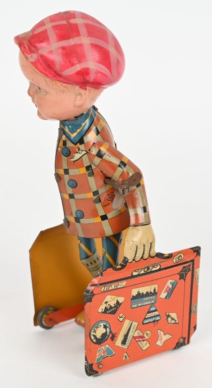 JAPAN TIN & CELLULOID WINDUP BOY w/ SUITCASES: All original in great condition. Nice colors. Works. 8" Excellent