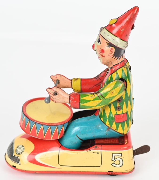 GERMAN TIN WINDUP DRUMMING CLOWN IN CAR: All original with great colors. Windup works. 6" Excellent