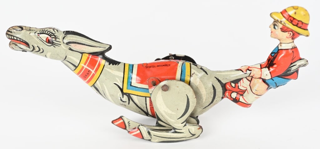 GERMAN TIN WINDUP BOY PULLING TAIL OF DONKEY: All original with great colors. Windup works. 6 1/2" Excellent