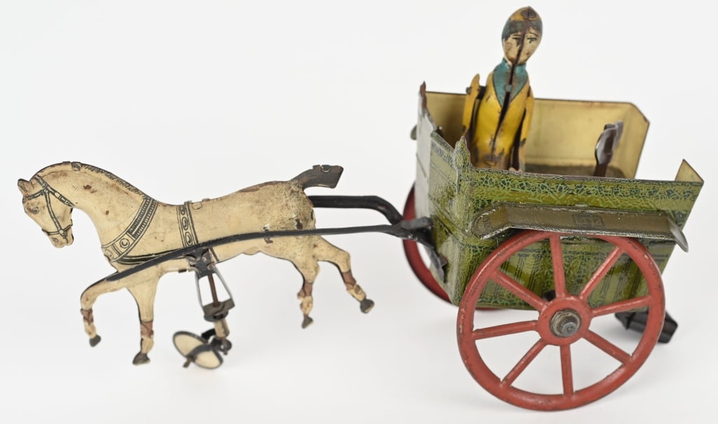 GERMAN TIN WINDUP LADY IN HORE CART: All original and in great shape. Windup works with eccentric action. 7" Excellent