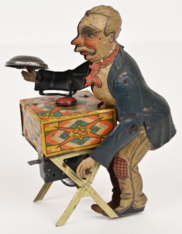 GERMAN TIN WINDUP ORGAN GRINDER: German tin windup Organ Grinder. All original. Old man cranks organ and music plays. Possible missing a piece from red disc. Works. 7" Excellent