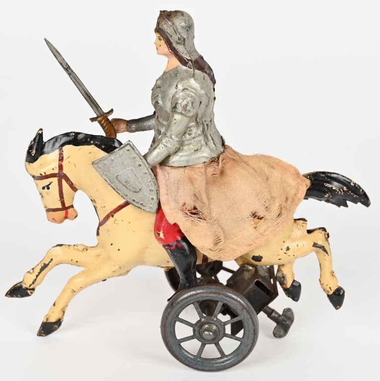 GERMAN WINDUP JOAN OF ARC ON HORSEBACK: German hand painted tin windup Joan of Arc on Horseback. All original in wonderful condition. Windup works as horse rolls along and figure moves up and down in the saddle. 7" Excellent
