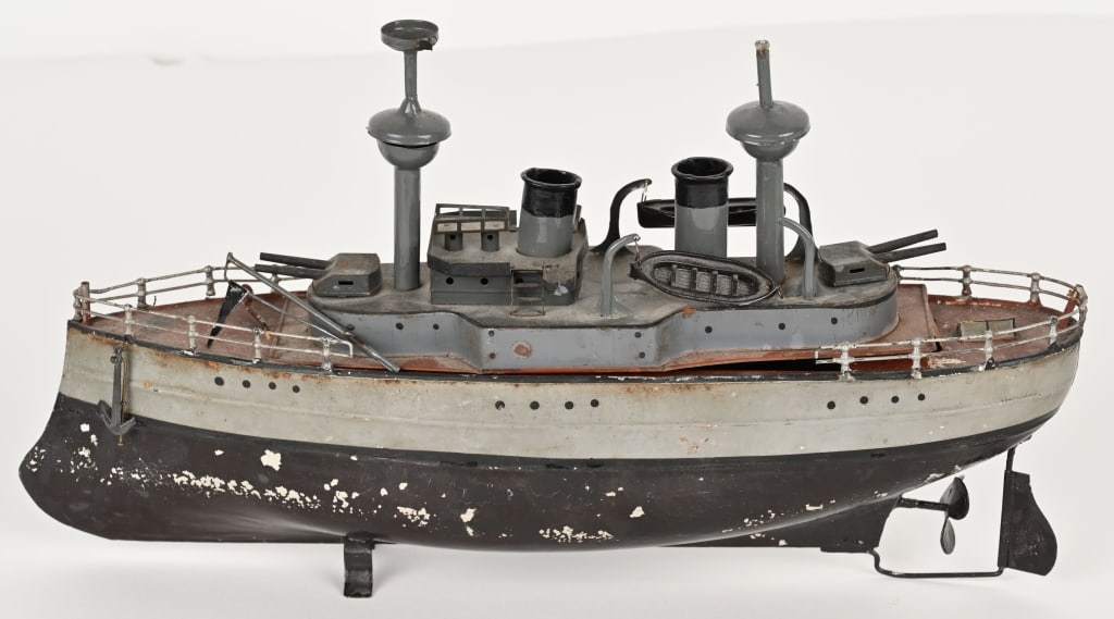 BING HAND PAINTED CLOCKWORK BATTLESHIP: Gebruder Bing hand painted tin clockwork Battleship. Nice looking boat with front and rear guns. Windup works. Has some repaint and masts are replaced. Small spot of railing loose. Desirable boat that