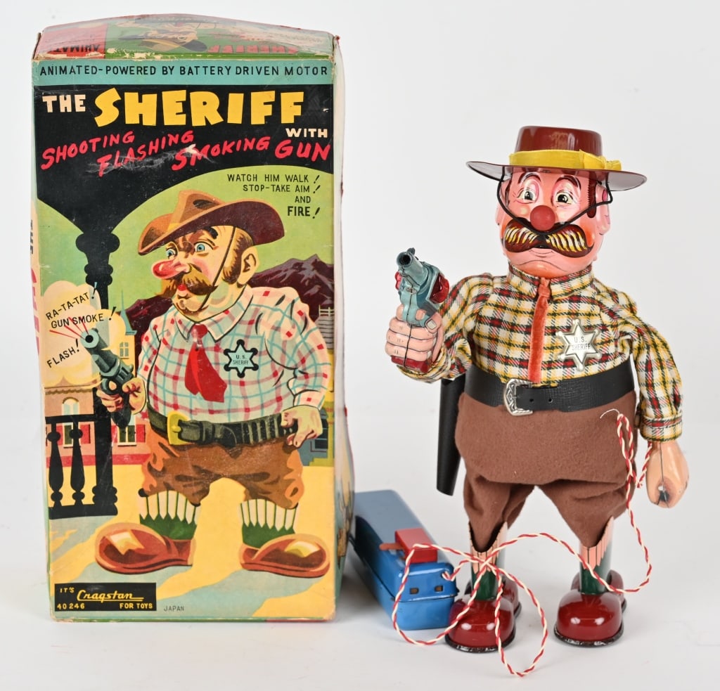JAPAN BATTERY OP THE SHERIFF WITH GUN w/ BOX: Japan battery operated Sheriff with shooting flashing smoking gun. All original and complete with hat. Has battery box remote control. Great condition. Has broken wire so not working. Boxed 12" Excell