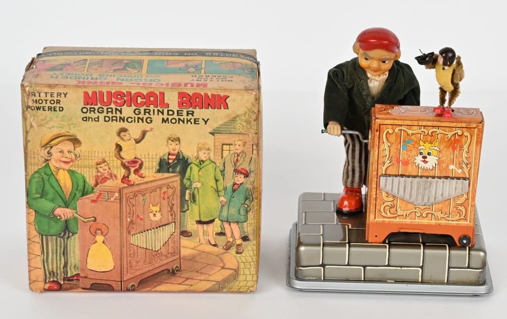 JAPAN BATTERY OP ORGAN GRINDER & MONKEY BANK: Japan battery operated Musical Bank "Organ Grinder and Dancing Monkey". All original and complete. Worked when tested. Comes with colorful original box. 7" Excellent