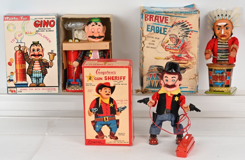 3- JAPAN BATTERY OP TOYS w/ BOXES: Lot includes: 1. Cragstan Two Gun Sheriff, 2. Rosko Gino Balloon Vender, 3. Brave Eagle drummer. All working with original boxes. The Sheriff and Gino have nice boxes Brave Eagle has a torn drum head 