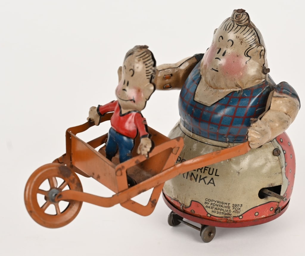 NIFTY TIN WINDUP POWERFUL KATRINKA & JIMMY: German tin windup comic character toy. Scarce Jimmy in wheelbarrow version. All original with nice colors. Windup works. Great early character toy. 7 1/2" Excellent