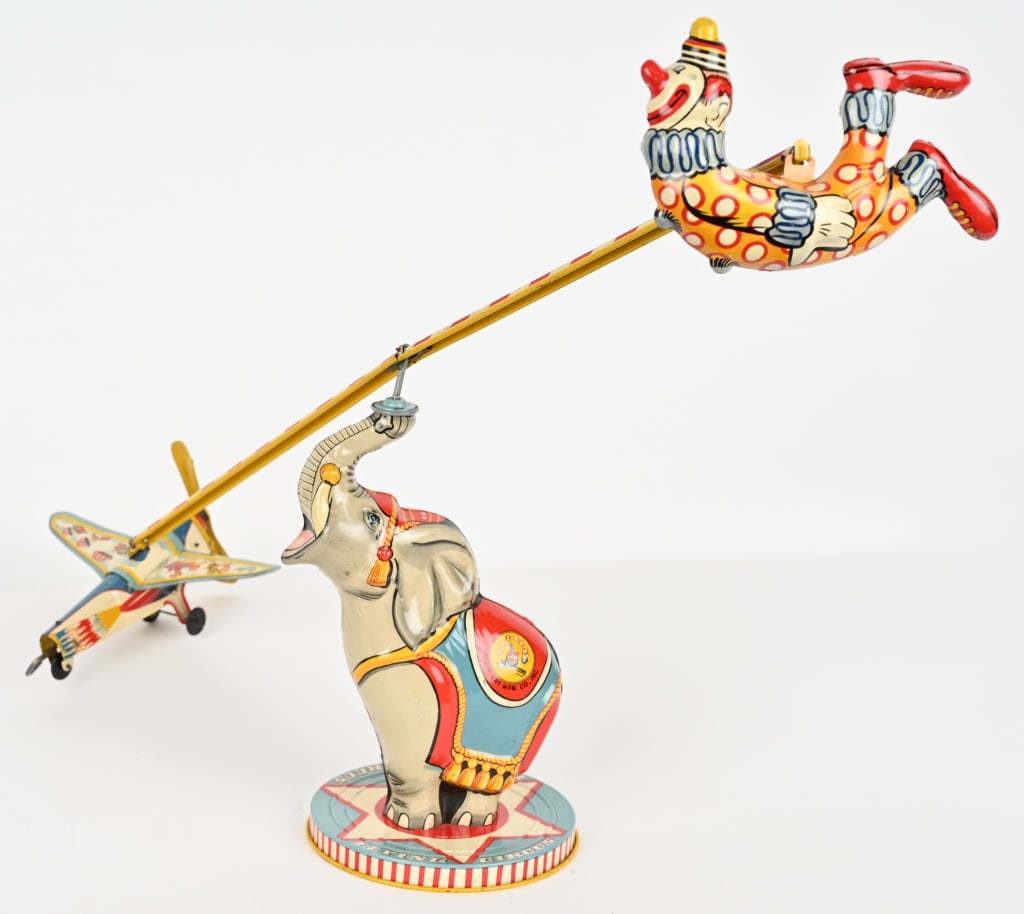 UNIQUE ART TIN WINDUP FLYING CIRCUS: Unique Art tin windup Flying Circus. All original and complete. Toy has great colors shine. Great looking Elephant and Clown. Windup works. 28" Excellent