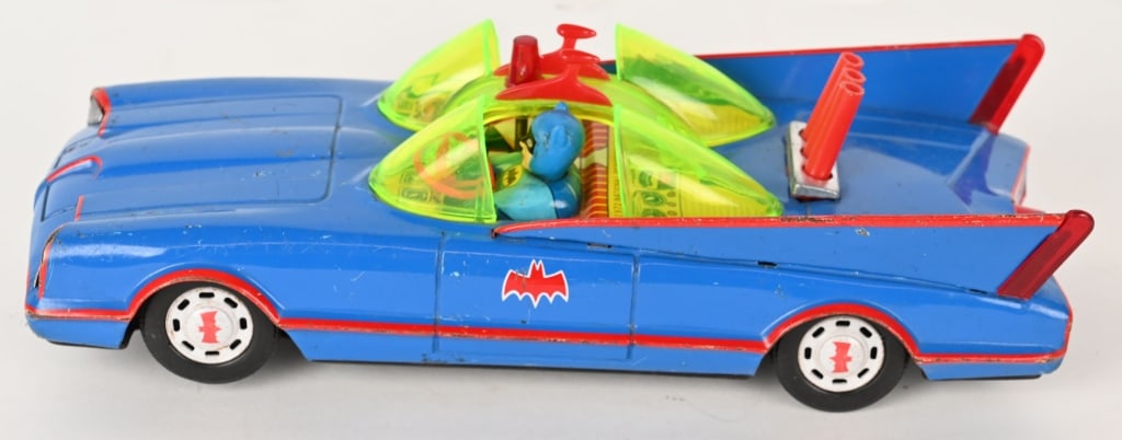 AHI BATTERY OP BATMOBILE: Japan battery operated Batmobile. All original tin Batmobile with vinyl Batman and Robin figures. Toy has nice colors. There is some spidering in spots and bottom. Battery box is clean. Worked when te