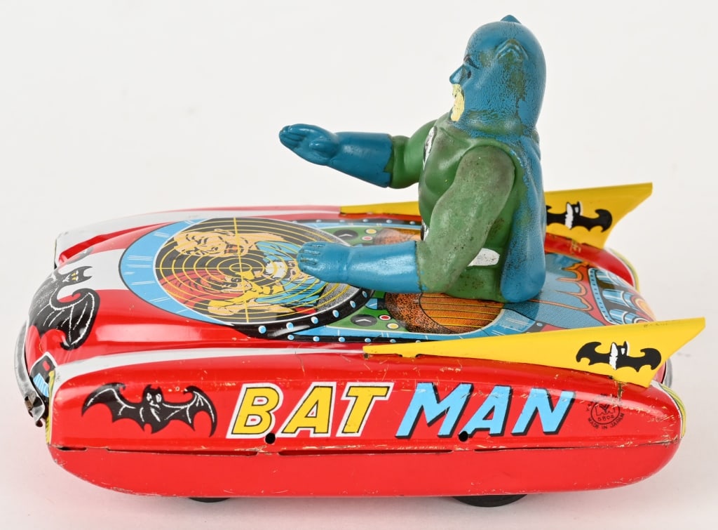 YANOMAN TIN FRICTION BATMAN VEHICLE: Japan tin friction Batman Vehicle by Yanoman. All original with great graphics. Toy has huge Batman vinyl figure. Friction works. Has some light wear mostly on bottom. A very Rare and Desirable Batman