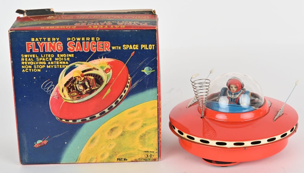 YOSHIYA BATTERY OP FLYING SAUCER w/ BOX: Japan battery operated Flying Saucer with Space Pilot. All original and looks never played with condition. Has great full body Space Pilot. Battery box is clean. Worked when tested. Boxed 8" Excellent