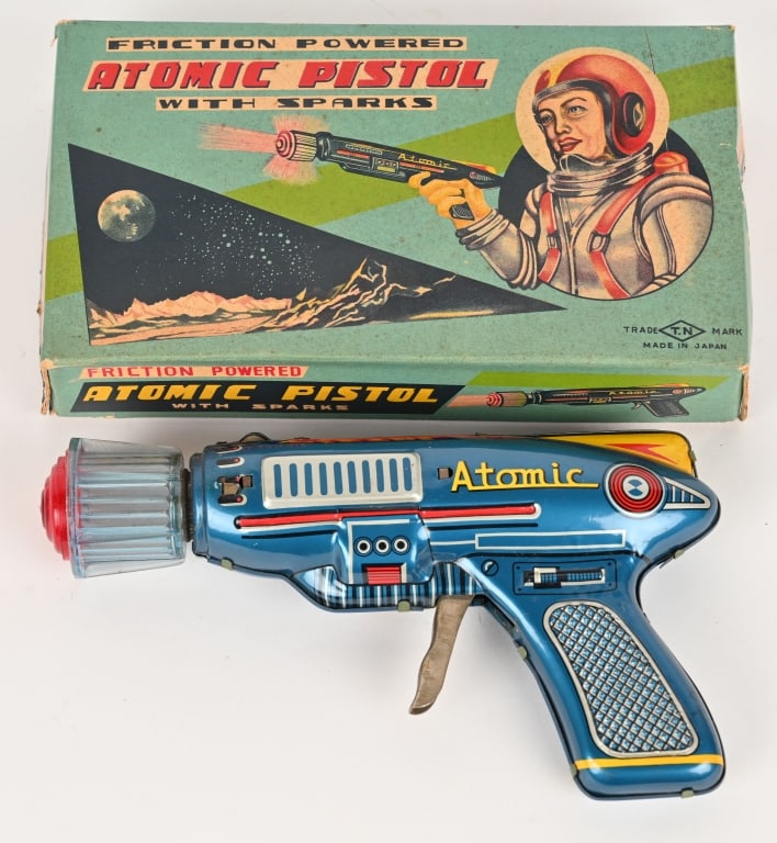 NOMURA TIN FRICTION ATOMIC PISTOL w/ BOX: Japan tin friction Atomic Pistol. All original and looks never played with. Has great colors. Works and plastic tip spins. Nice looking Space Gun. With crisp Box with great graphics. 7 1/2" Excellent