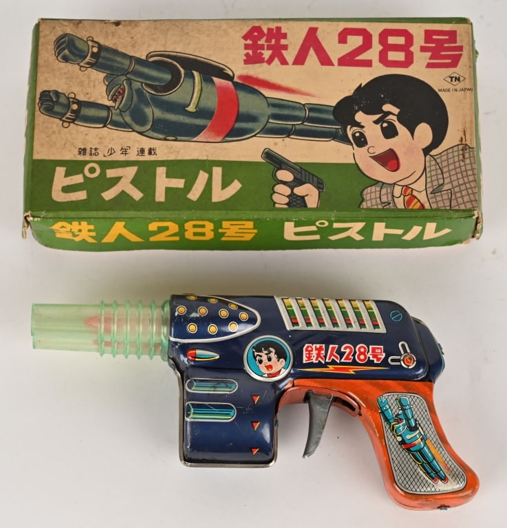 NOMURA TIN FRICTION TETSUJIN GUN w/ BOX: Japan tin friction Tetsujin Double Barrel Gun. All original with great colors and graphics. Works great . Comes with scarce colorful Box. One edge has a little loss. 8 1/2" Excellent