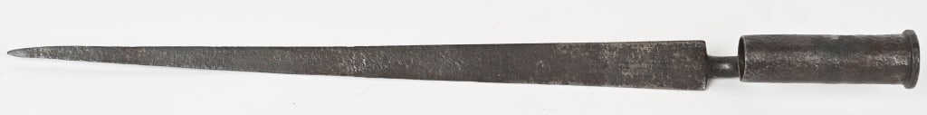 REV WAR PERIOD BROWN BESS SOCKET BAYONET: This British military accoutrement is an original angular socket bayonet used with their Brown Bess smoothbore musket. The triangular blade exhibits a spear shape and the two “bottom”