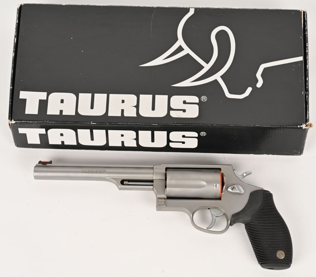 TAURUS "THE JUDGE" .45 / 410 REVOLVER W/ BOX: SERIAL NUMBER: CT825037. BARREL: 6 1/2". CALIBER: .45 COLT/.410 GA. MANUFACTURED: 2012. Stainless five shot double action with rubber grips, light gathering front sight pipe. Factory box and manual. C
