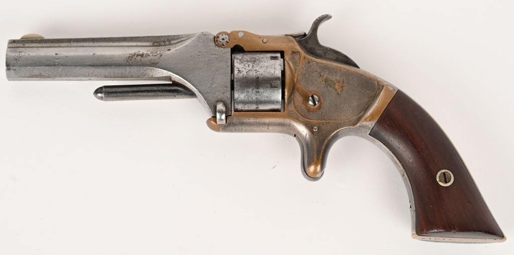 SMITH & WESSON MODEL No.1 SECOND ISSUE 22 SHORT: SERIAL NUMBER: 71019 BARREL: 3 3/16" CALIBER: 22 SHORT 7 SHOT MANUFACTUERD: 1860-1868 Brass frame with silver plating. Barrel and cylinder were blue finish and tip up design. Grips are rosewood and nu