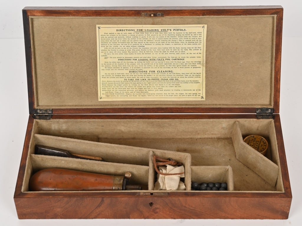 COLT BLACK POWDER WOOD PISTOL CASE: This mahogany case is built to house your fine Colt pistol. It contains (1) 30 caliber mold, Eley Bro caps, powder flask, key (box is lockable) and lead round balls, 15 1/4"x6 1/2"x3" (LxWxH) exterior